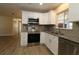 Modern kitchen with ample cabinet space, stainless steel appliances, new floors and granite counters at 6472 Sw 106Th Pl, Ocala, FL 34476