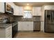 Updated kitchen with stainless steel appliances, modern countertops, backsplash, and wood-look flooring at 6472 Sw 106Th Pl, Ocala, FL 34476