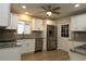 Bright kitchen with white cabinets, new stainless steel appliances, granite countertops and new floors at 6472 Sw 106Th Pl, Ocala, FL 34476