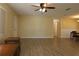 View of the open living room, with neutral colored walls, updated floors, and a ceiling fan at 6472 Sw 106Th Pl, Ocala, FL 34476