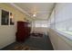 Enclosed sunroom with neutral walls, carpet floors, ceiling fan and lots of windows at 6472 Sw 106Th Pl, Ocala, FL 34476