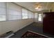 Enclosed sunroom with neutral walls, carpet floors, ceiling fan and lots of windows at 6472 Sw 106Th Pl, Ocala, FL 34476