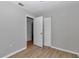 Cozy bedroom features wood-look floors, neutral walls, closet space, and a large window at 6820 Se 108Th St, Belleview, FL 34420