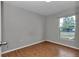 Comfortable bedroom showcasing wood-look floors, neutral walls, and a window at 6820 Se 108Th St, Belleview, FL 34420