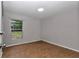 Bedroom with wood-look flooring, a large window with a view, and neutral-colored walls at 6820 Se 108Th St, Belleview, FL 34420