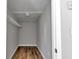 Walk-in closet featuring neutral walls and wood-look flooring, complete with wire shelving at 6820 Se 108Th St, Belleview, FL 34420