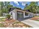 Exterior view of a home featuring modern design, large windows, and mature landscaping at 6820 Se 108Th St, Belleview, FL 34420