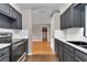 Modern kitchen with stainless steel appliances, gray cabinets, and sightlines to living area at 6820 Se 108Th St, Belleview, FL 34420