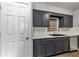 The kitchen features gray cabinets, modern appliances, and updated countertops at 6820 Se 108Th St, Belleview, FL 34420