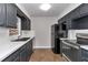 Well-lit kitchen featuring dark cabinets, white countertops, and modern appliances at 6820 Se 108Th St, Belleview, FL 34420