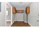 Laundry area with storage cabinets, a water heater, and access to another room at 6820 Se 108Th St, Belleview, FL 34420