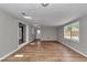 Bright living room features new flooring, light gray walls, and a large window for natural light at 6820 Se 108Th St, Belleview, FL 34420
