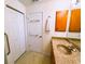 Well-lit bathroom featuring a sink, closet, and accessible fixtures at 7134 Sw 129Th Terrace Road, Ocala, FL 34481