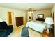 Comfortable bedroom featuring a four-poster bed and a ceiling fan at 7134 Sw 129Th Terrace Road, Ocala, FL 34481