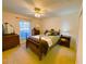 Cozy bedroom with a ceiling fan, natural light, and comfortable furniture for a relaxing atmosphere at 7134 Sw 129Th Terrace Road, Ocala, FL 34481