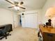 Bedroom featuring a ceiling fan, closet space, and neutral carpeting throughout the room at 7134 Sw 129Th Terrace Road, Ocala, FL 34481