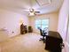 Cozy bedroom with a ceiling fan, natural light, and space for a home office setup at 7134 Sw 129Th Terrace Road, Ocala, FL 34481