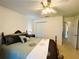 Bedroom with a decorative bed, ceiling fan, closet and comfortable neutral tone carpeting at 7134 Sw 129Th Terrace Road, Ocala, FL 34481