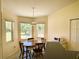 Bright breakfast nook featuring a round table with chairs, illuminated by natural light from surrounding windows at 7134 Sw 129Th Terrace Road, Ocala, FL 34481