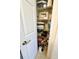 Organized closet with shelving, maximizing storage space for linens, supplies, and other essentials at 7134 Sw 129Th Terrace Road, Ocala, FL 34481