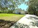 Charming single-story home with a well-manicured lawn and long driveway surrounded by mature trees at 7134 Sw 129Th Terrace Road, Ocala, FL 34481