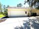 Spacious two car garage with concrete driveway and well-maintained landscaping at 7134 Sw 129Th Terrace Road, Ocala, FL 34481