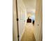 Hallway leading to a cozy bedroom with a dresser and inviting natural light from a window at 7134 Sw 129Th Terrace Road, Ocala, FL 34481