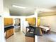 Kitchen overlooking dining area, featuring wood cabinets and essential appliances; an efficient layout at 7134 Sw 129Th Terrace Road, Ocala, FL 34481