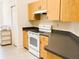Functional kitchen featuring wood cabinets, neutral countertops, and essential appliances for cooking at 7134 Sw 129Th Terrace Road, Ocala, FL 34481