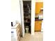 Open pantry door revealing stocked shelves, situated near the kitchen area, providing extra storage at 7134 Sw 129Th Terrace Road, Ocala, FL 34481