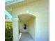Inviting covered front porch with a decorative archway and beautiful landscaping, creating a warm welcome at 7134 Sw 129Th Terrace Road, Ocala, FL 34481
