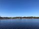 Waterfront view of the dam over calm waters with the horizon in the distance at 7134 Sw 129Th Terrace Road, Ocala, FL 34481