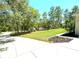 Expansive lush backyard, perfect for outdoor activities, with an open green space and natural landscaping at 7134 Sw 129Th Terrace Road, Ocala, FL 34481