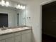 Bathroom featuring a double sink vanity and framed mirror at 74 Pine Trace Crse, Ocala, FL 34472