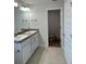 Bright bathroom features a double sink vanity and tile floors at 74 Pine Trace Crse, Ocala, FL 34472