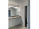 Bathroom featuring a double sink vanity, modern fixtures, and clean, neutral color scheme for a serene atmosphere at 74 Pine Trace Crse, Ocala, FL 34472