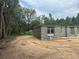 Image shows cinder block frame on sandy lot, ready for the next phase of construction, and green trees surround the building at 74 Pine Trace Crse, Ocala, FL 34472