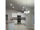 Beautiful kitchen with granite countertops, stainless steel appliances and a tile floor at 74 Pine Trace Crse, Ocala, FL 34472