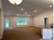 Bright living room features an open layout, recessed lighting, and an adjacent kitchen with a breakfast bar at 74 Pine Trace Crse, Ocala, FL 34472