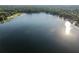 The lake community aerial view features calm waters and lush greenery, creating a serene environment at 754 Se 167Th Court Rd, Silver Springs, FL 34488