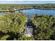 Drone view of a tranquil lake surrounded by lush trees, showing a home with private access and natural beauty at 754 Se 167Th Court Rd, Silver Springs, FL 34488
