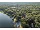 Lush, treed, aerial view of lakefront property with shoreline, mature trees, and beautiful lake views at 754 Se 167Th Court Rd, Silver Springs, FL 34488