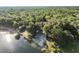 Aerial view of the lakefront property, surrounded by lush greenery and mature trees at 754 Se 167Th Court Rd, Silver Springs, FL 34488