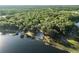 Expansive aerial view highlighting the property's wooded area and lakefront access at 754 Se 167Th Court Rd, Silver Springs, FL 34488