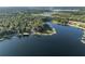 Aerial view of lakefront property surrounded by lush trees with boat dock and private water access at 754 Se 167Th Court Rd, Silver Springs, FL 34488