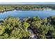 Overhead shot of a picturesque lake and verdant landscape, highlighting waterfront homes and meandering roads at 754 Se 167Th Court Rd, Silver Springs, FL 34488