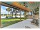 Relaxing back porch complete with ceiling fan, recessed lights, a grill and outdoor seating at 754 Se 167Th Court Rd, Silver Springs, FL 34488