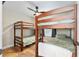 Cozy bedroom with hardwood floors, bunk beds, and ceiling fan at 754 Se 167Th Court Rd, Silver Springs, FL 34488