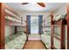 Bright bedroom featuring two sets of bunk beds and a window with curtains at 754 Se 167Th Court Rd, Silver Springs, FL 34488