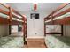 A shared bedroom has matching sets of bunk beds and a mounted television at 754 Se 167Th Court Rd, Silver Springs, FL 34488